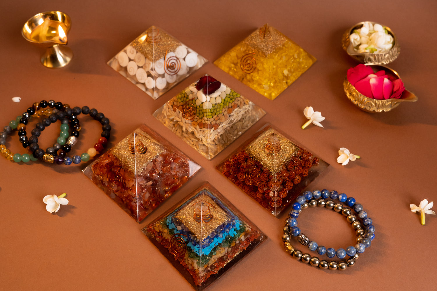 Beautifully arranged crystal pyramids with a gemstone bracelet, designed for balance, protection, and well-being.