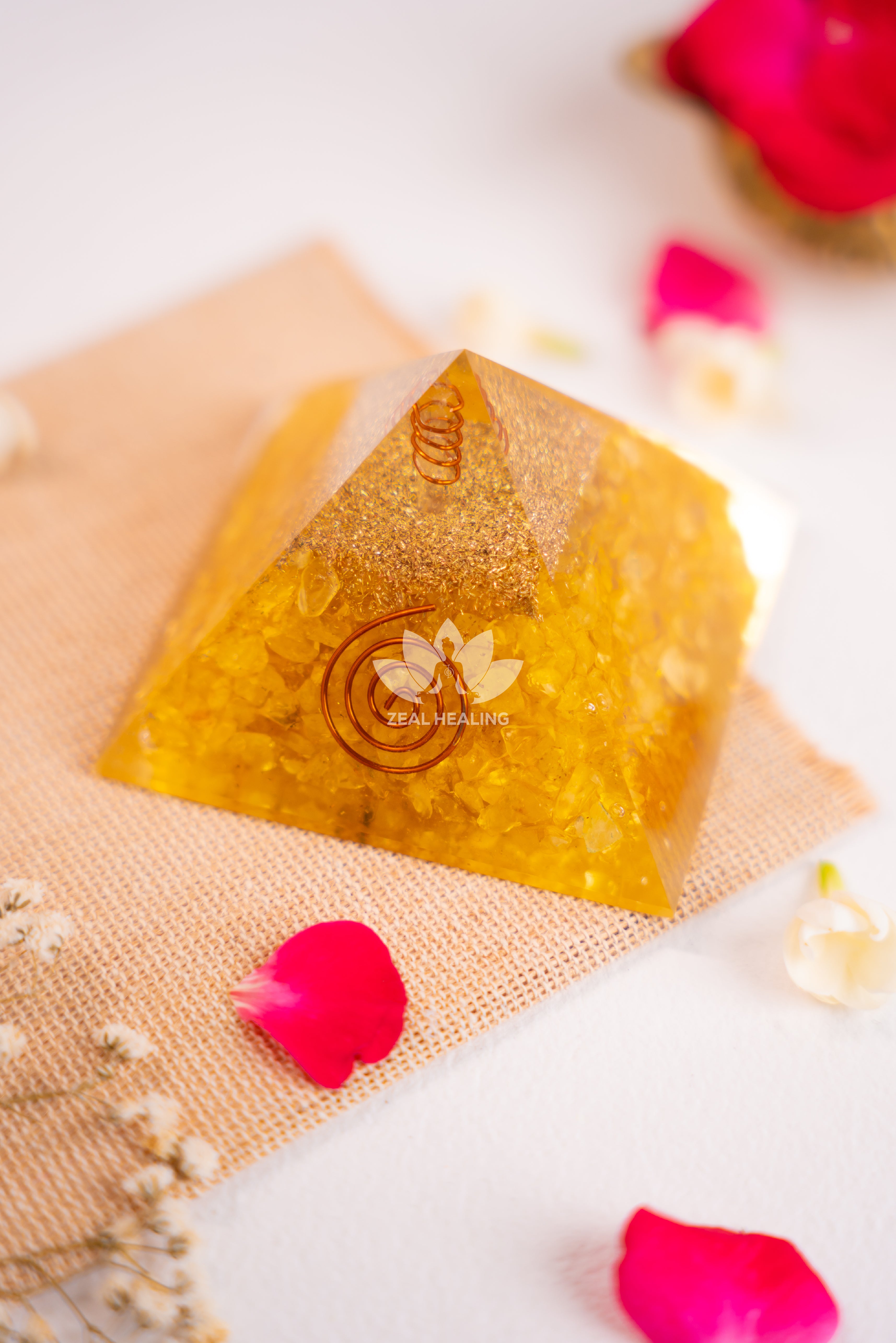 Polished Citrine pyramid with warm tones, radiating positivity and prosperity.